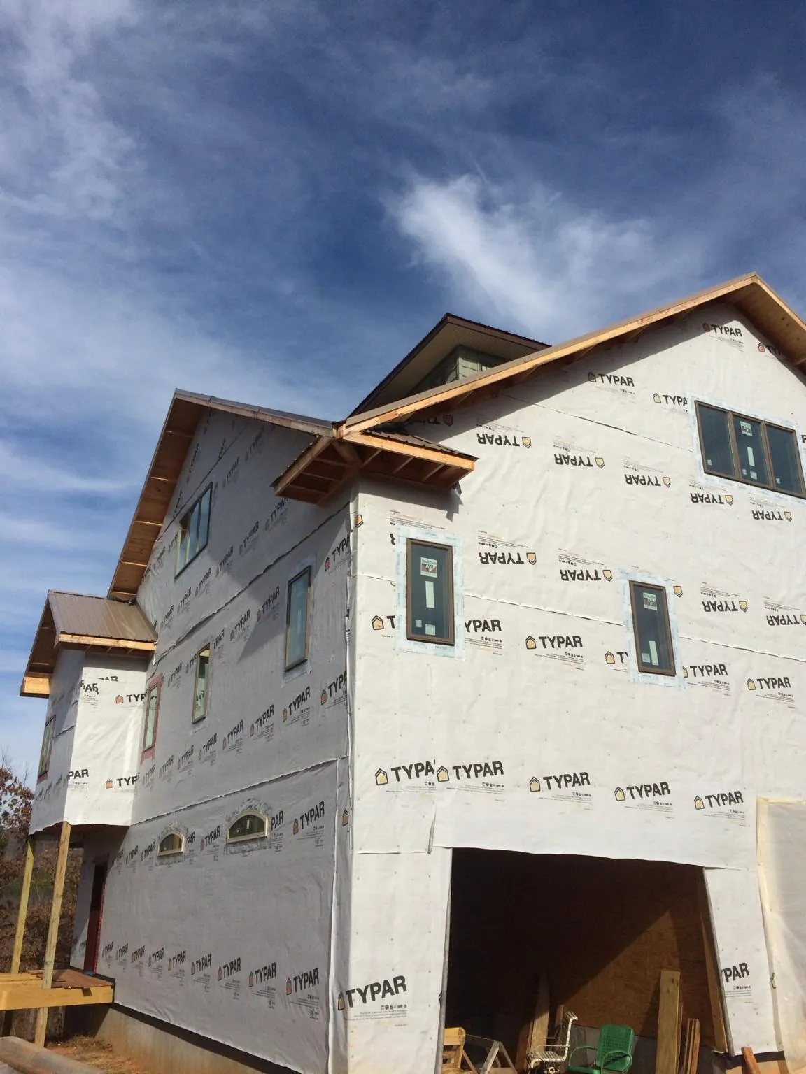 Stick built house wrapped in Typar with new roof framing and dormers in Malo